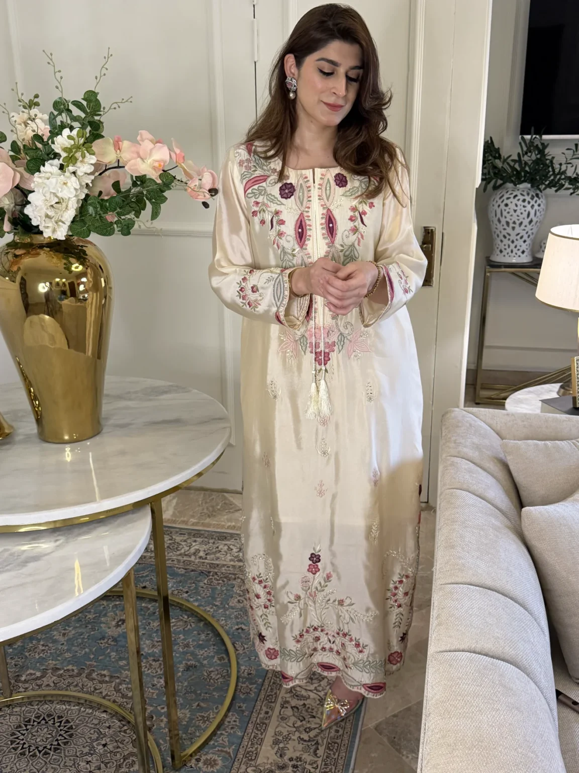 Ivory silk kaftan with tasseled cords over a front panel of wine almond shapes and pink flowers, and wine and pink flowers on sage vines along a scalloped hem